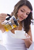 Girl pouring tea into a cup