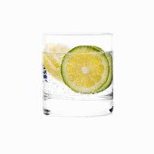 A glass of water with slices of lime