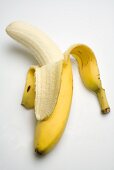 A banana, half peeled