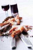 Prawns, knife and red wine