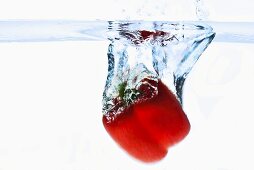 Red pepper falling into water