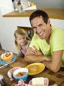 Father and daughter at breakfast table