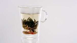 A cup of tea with tea flower