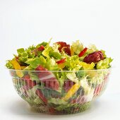 Mixed salad in plastic bowl, close-up