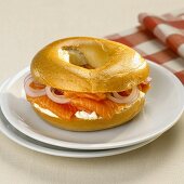 Bagel filled with salmon, cream cheese and onion