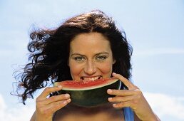 Young woman eating watermelon, portrait