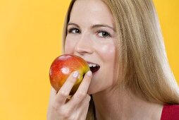 Frau beisst in Apfel