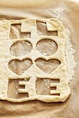 Biscuit dough with the word 'LOVE' cut out twice