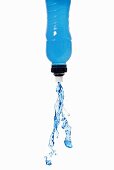 Blue energy drink squirting out of bottle