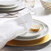 Festive place-setting with fabric napkin & slice of baguette
