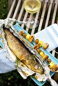 Barbecued trout with mushroom and potato skewers