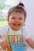 Girl eating pasta with bolognese sauce