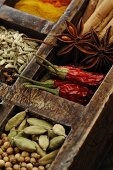 Assorted spices in wooden box (close-up)