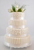 Four-tiered white wedding cake with floral decoration