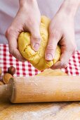 Hands kneading biscuit dough