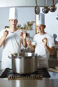 Two chefs satisfied with the results of their culinary skills