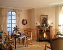 Weihnachtlich dekorierter Raum: Kamin, Eßtisch, Drahtbaum