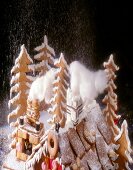 Gingerbread and cookies in the form of witch house and fir forest