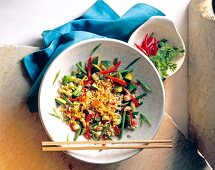 Basmati rice with curry and leek in bowl with chopsticks, overhead view