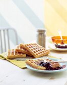 Cornmeal waffles with blueberry compote on plate