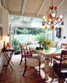 Dining area overlooking the garden and wooden table with old fashioned chairs
