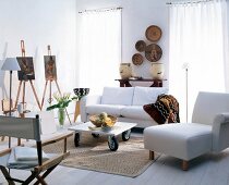 Living room with white furniture and painting