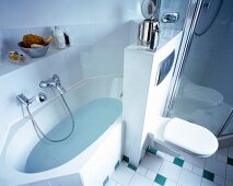 Alcove bathtub and commode in bathroom