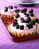 Short crust torteletts with mascarpone cream filling and black berries