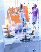 Laid dining table with blue glasses and sparklers