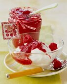 Vanilla quark with topping of raspberries and rhubarb jam in glass bowl