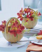 Decoration idea: hollowed-out honeydew melon as a flower basket, lilies