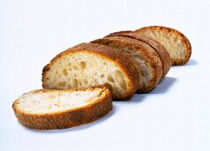 Close-up of slices of ciabatta white bread on white background