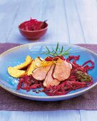 Marinated duck breast with red cabbage on plate