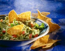 Guacamole with tacos in serving dish