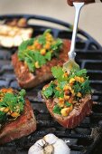 Close-up of tuna with peanut and coriander topping on grill