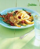 Spaghetti with fennel and black olives on plate