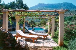 Terrace with sun loungers and swimming pool of the mansion Son Bleda, Spain