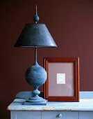 Blue lamp and photo frame on table