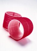 Close-up of red velcro hair curlers on white background