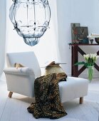 White chaise chair with leopard print blanket