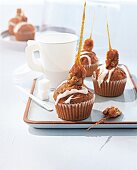 Bananas muffin with cream, walnut and caramel on serving tray