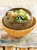 Close-up of Gaeng Keow Wahn Gai green chicken curry in serving bowl