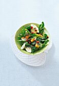 Spinach salad with mozzarella and crotons in bowl