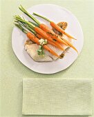 Coley fillet with carrots on plate