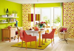 Colourful dining room with green coloured walls and large window