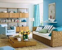 Blue painted living room with wooden flooring, rattan wicker sofa and bookshelf