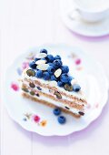 Buckwheat cake with blueberries and almonds on plate