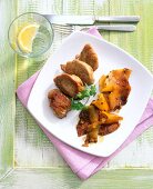 Pork tenderloin with grilled pineapple on plate
