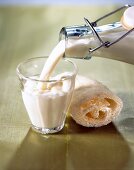 Close-up of Goat's milk being poured in a small glass