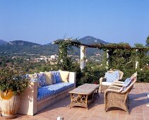 Terrace with brick bench and wicker furniture in Mallorca, Spain